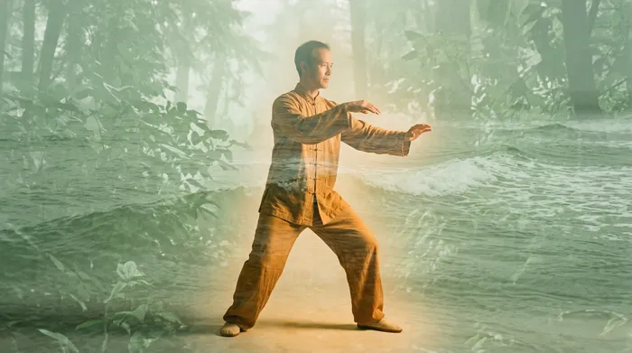 Double exposure of a practitioner performing shibashi wave hands blended with sage green ocean waves