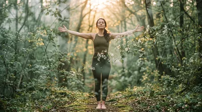 Double exposure of a practitioner with arms spread wide blended with flowering sage green branches