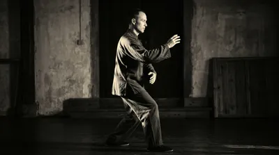 Practitioner in the compact Wu style posture with the characteristic inclined straight body